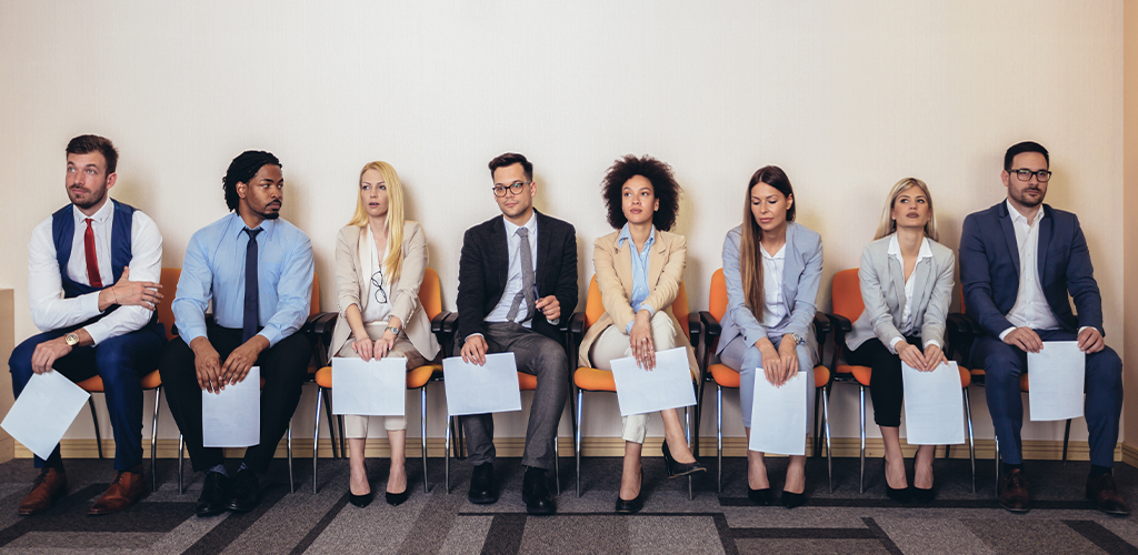 Job candidates waiting for interview in office chairs