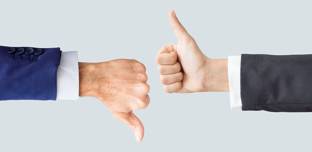 Business executives with a thumbs up and thumbs down