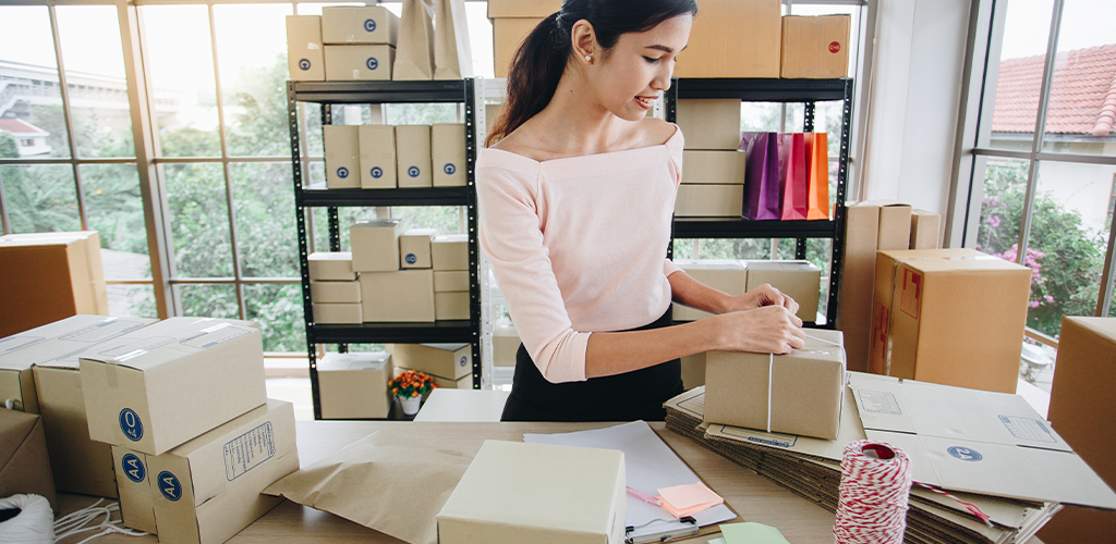 Store owner preparing product packages