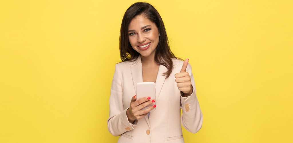 Business woman with phone and thumbs up benefits